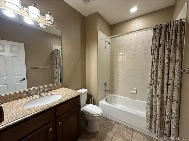 a bathroom with a double vanity sink toilet and shower