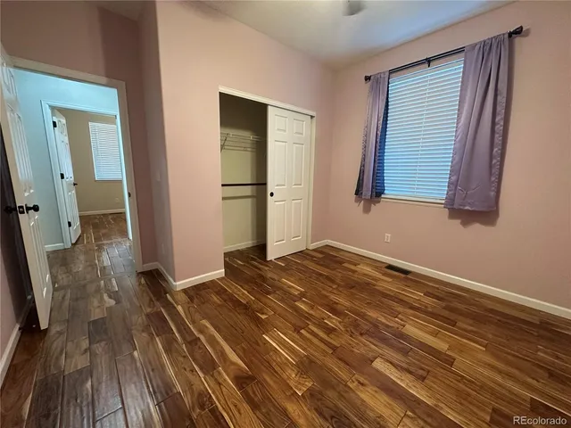 a view of a room with wooden floor and bathroom