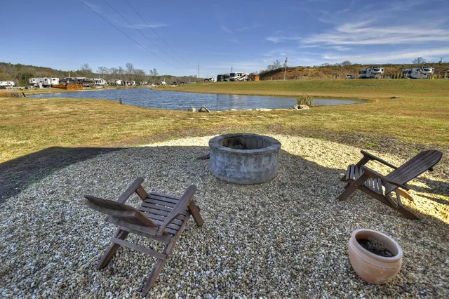 a view of a lake with a table and chairs