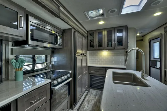 a kitchen with stainless steel appliances granite countertop a sink and dishwasher