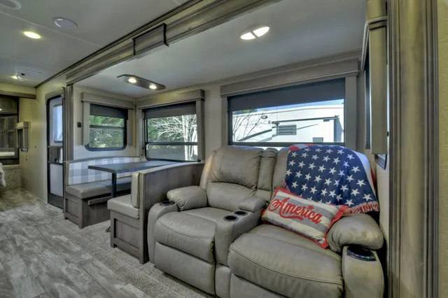 a living room with furniture and large window