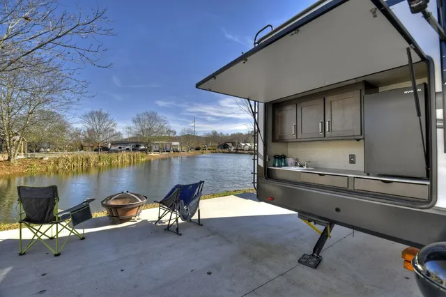 a lake view with table and chairs