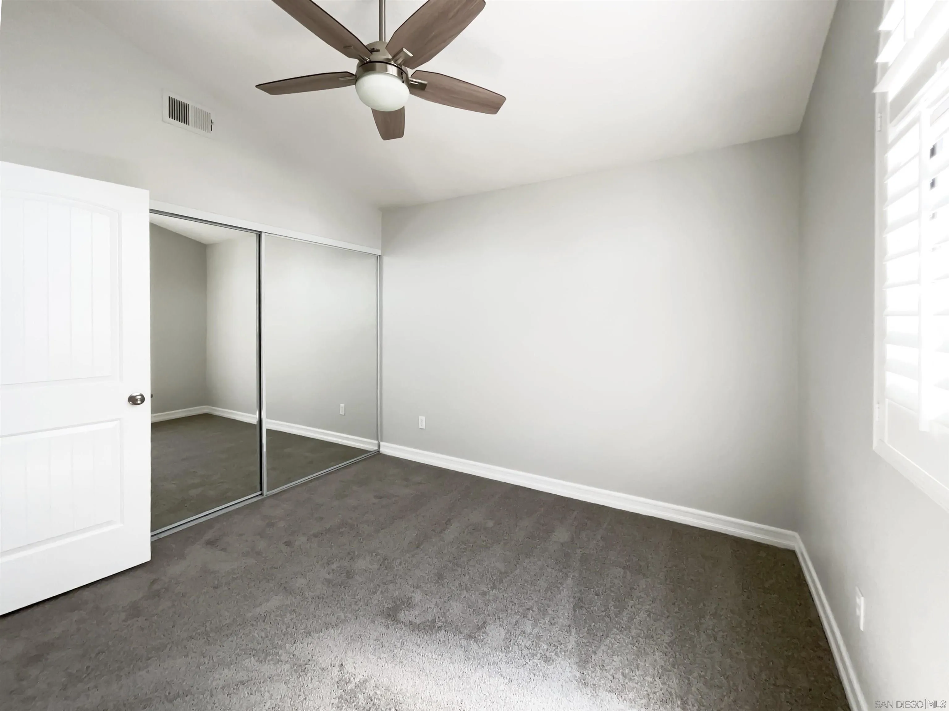 7922 Sunset Terrace Lemon Grove, CA 91945 - Photo 15 of 22 an empty room with a window and a fan