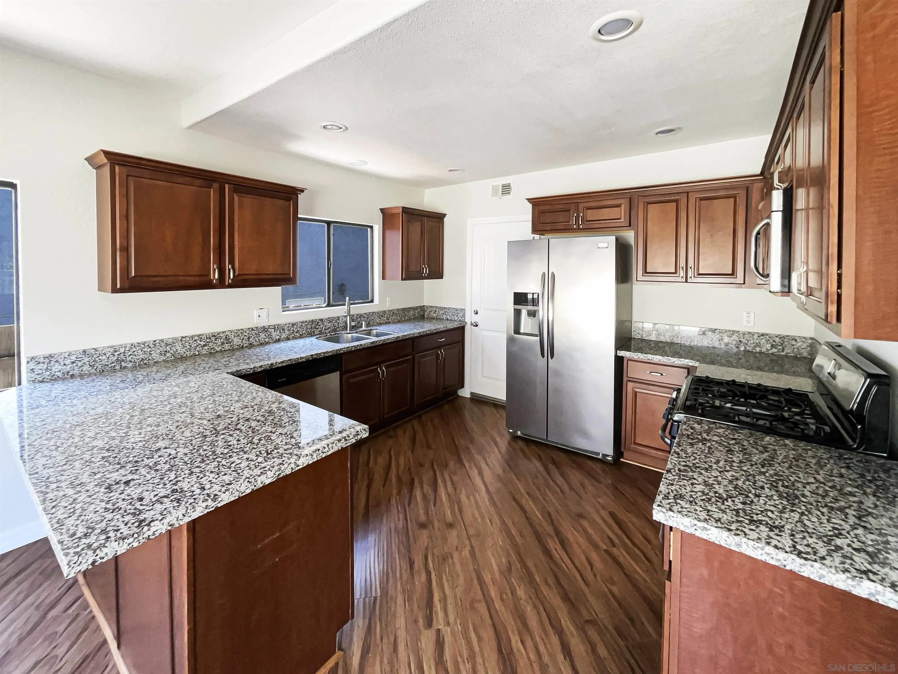 7922 Sunset Terrace Lemon Grove, CA 91945 - Photo 6 of 22 a kitchen with stainless steel appliances granite countertop wooden cabinets stove and granite counter tops
