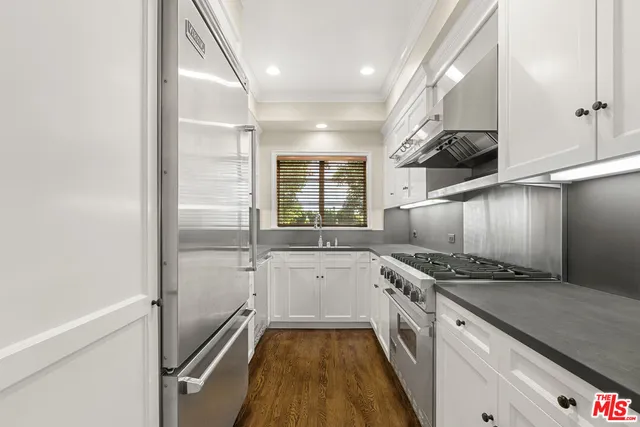 a kitchen with stainless steel appliances granite countertop a sink and a stove