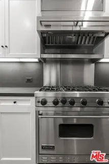 a stove top oven sitting inside of a kitchen