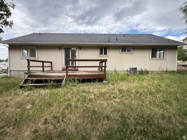 838 East Mountain Road Logan, UT 84321 - Photo 34 of 37 Rear exterior featuring a wood deck with railings, stucco siding, multiple windows, and a sliding glass door