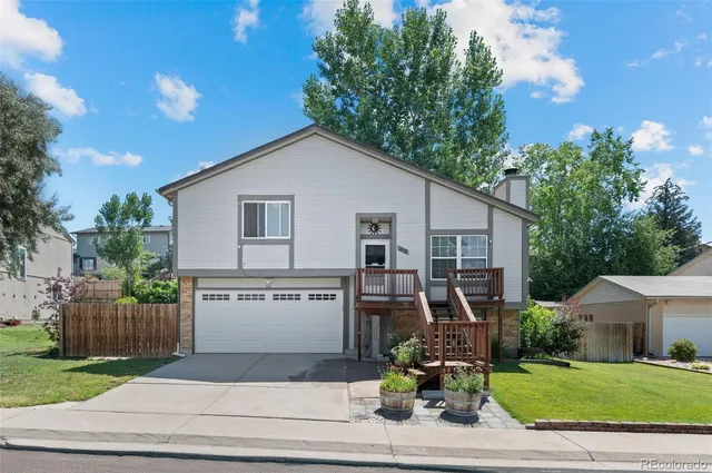 a front view of house with deck and yard