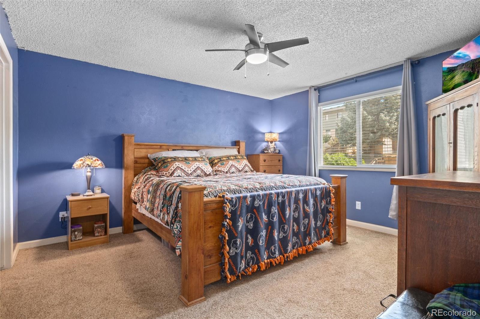 9648 Lane Street Thornton, CO 80260 - Photo 13 of 27 a bedroom with a bed and a chandelier