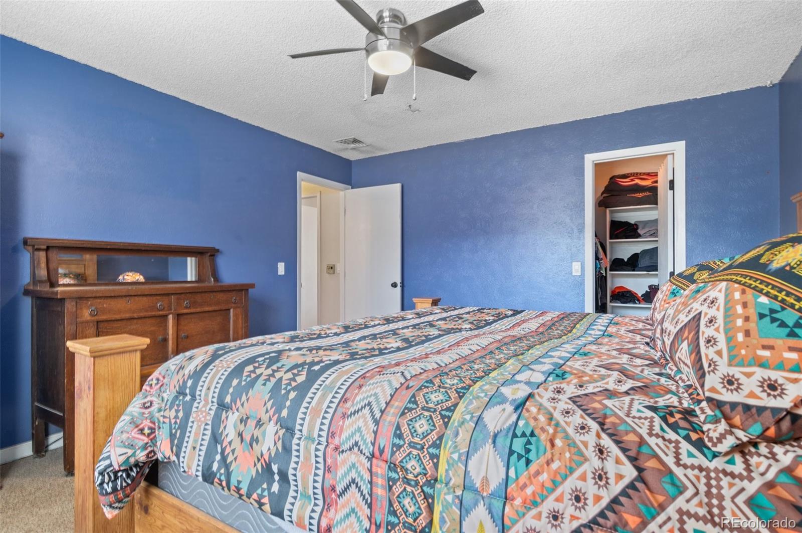 9648 Lane Street Thornton, CO 80260 - Photo 14 of 27 a bedroom with a bed and dresser