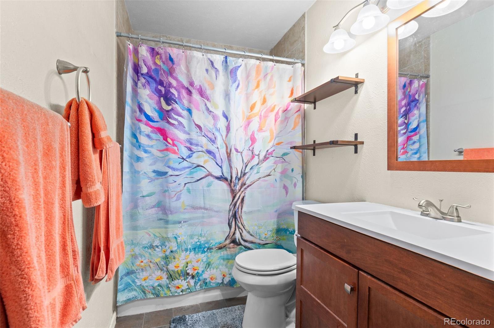 9648 Lane Street Thornton, CO 80260 - Photo 16 of 27 a bathroom with a sink toilet and shower curtain