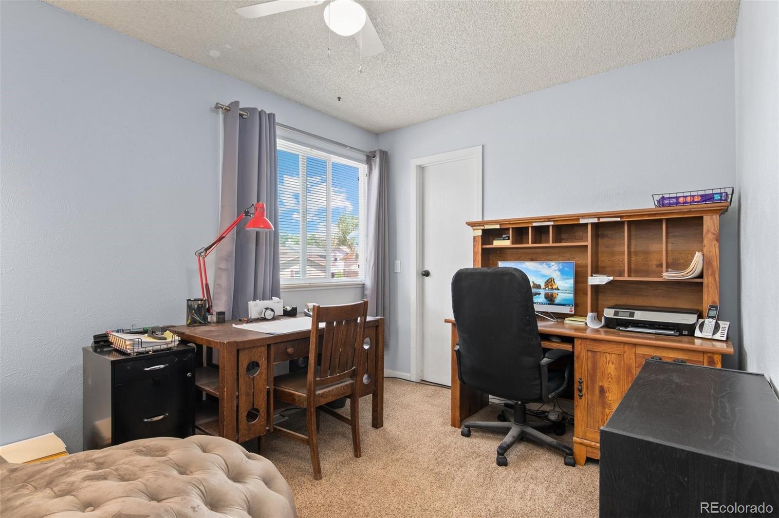 9648 Lane Street Thornton, CO 80260 - Photo 17 of 27 a view of a workspace with furniture and a window