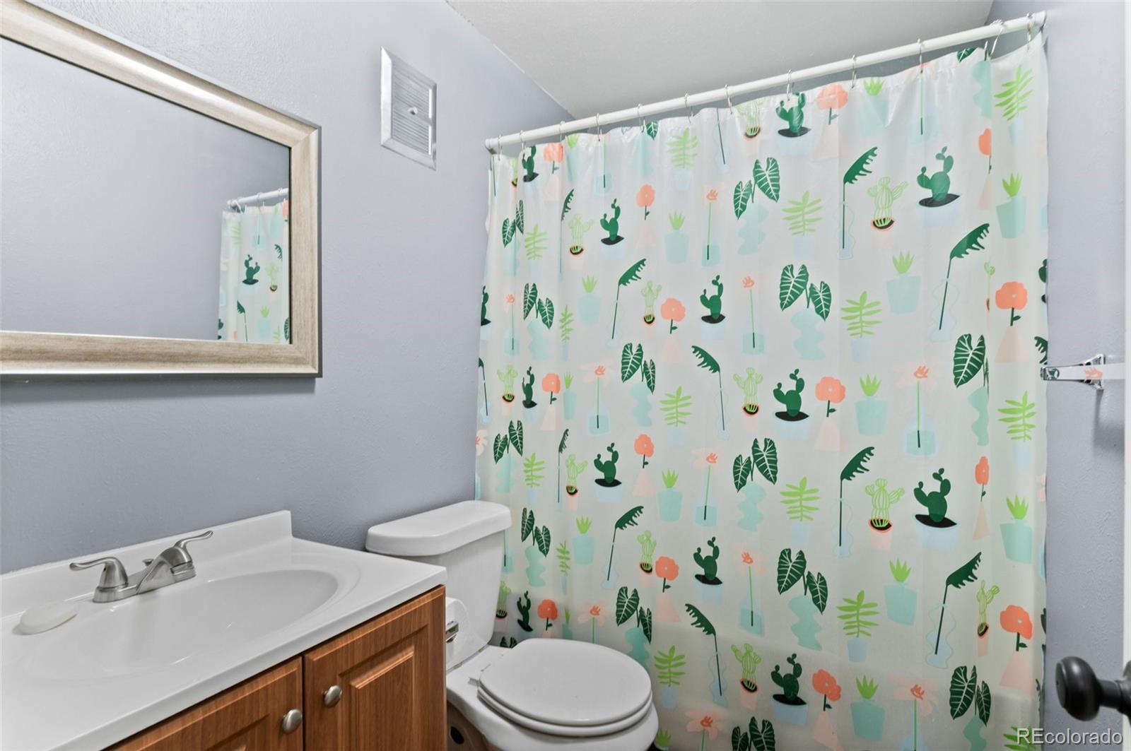 9648 Lane Street Thornton, CO 80260 - Photo 19 of 27 a bathroom with a sink toilet and a mirror