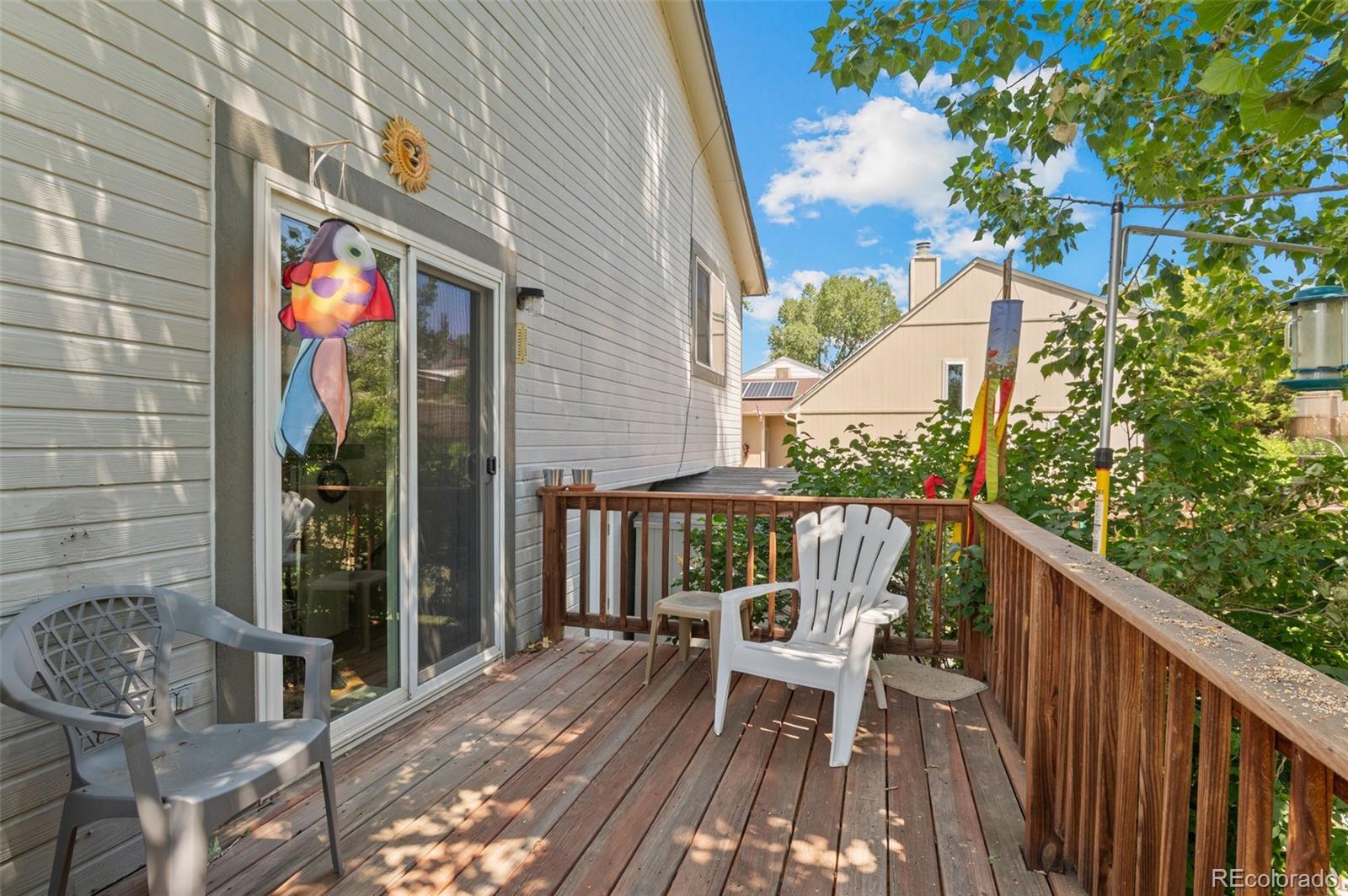 9648 Lane Street Thornton, CO 80260 - Photo 20 of 27 a view of balcony with wooden floor and outdoor seating