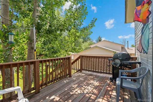 a view of a backyard with table and chairs and potted plants