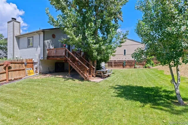 a house view with a sitting space and garden