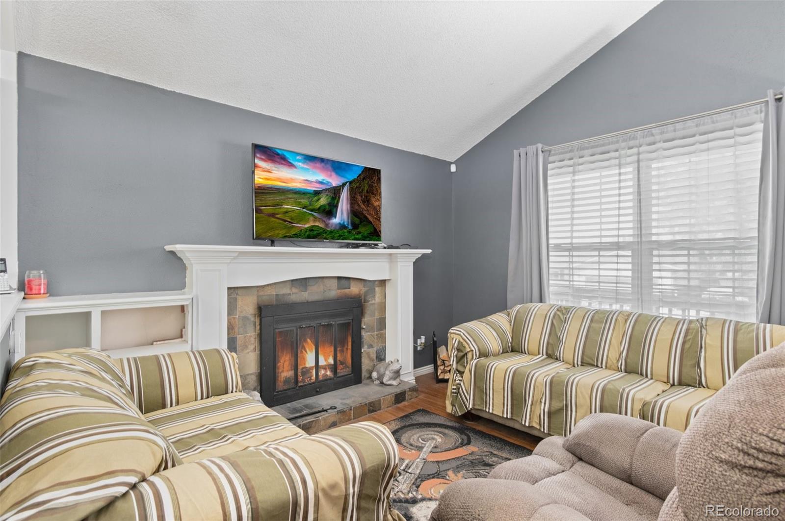 9648 Lane Street Thornton, CO 80260 - Photo 7 of 27 a bedroom with a bed and a fireplace