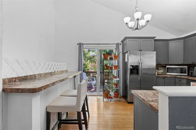 a utility room with wooden floor and furniture