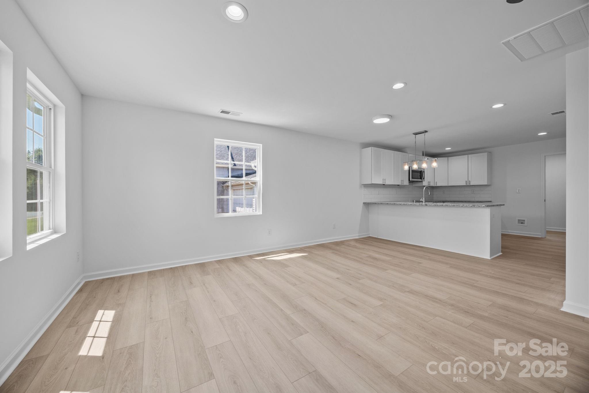 409 Shaver Street Salisbury, NC 28144 - Photo 12 of 39 a view of a kitchen with wooden floor and a window