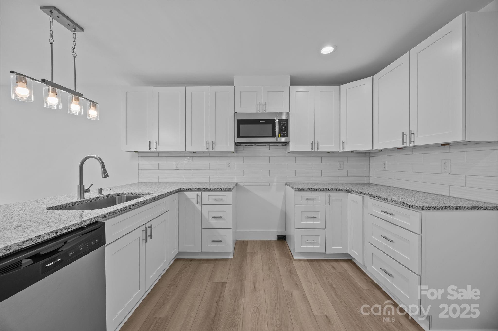 409 Shaver Street Salisbury, NC 28144 - Photo 15 of 39 a kitchen with stainless steel appliances granite countertop a sink stove and white cabinets