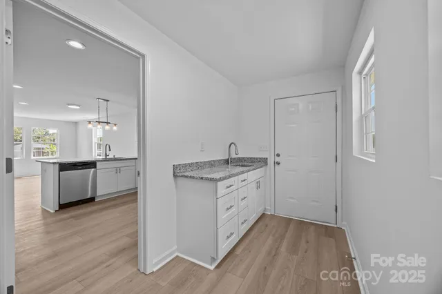 a kitchen with granite countertop a sink and a stove top oven