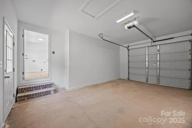 an empty room with a ceiling fan and window