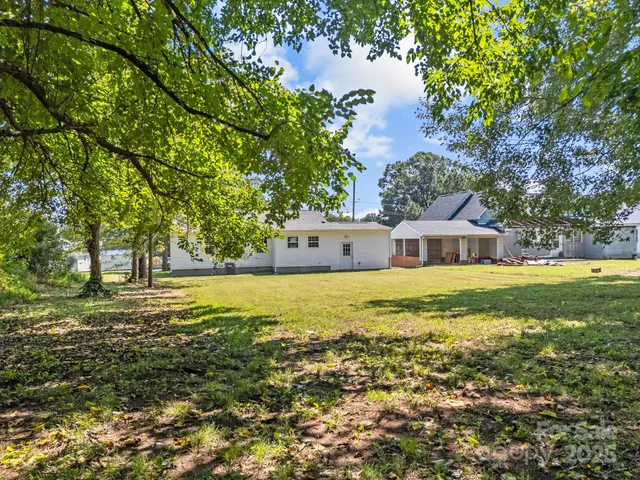 a front view of a house with a big yard