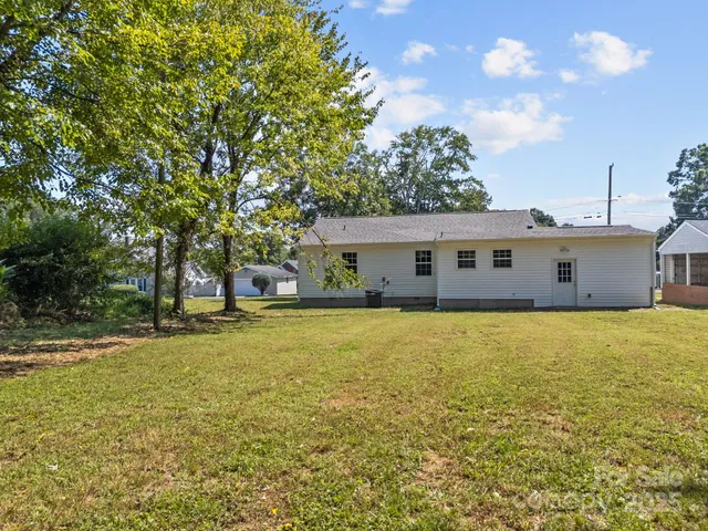 a front view of house with yard and trees