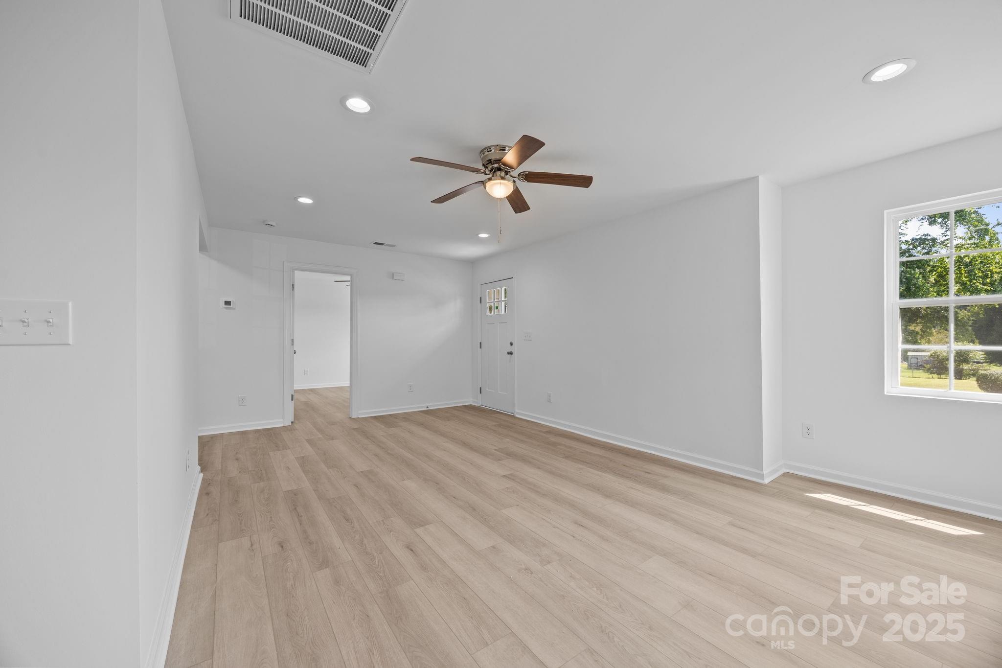 409 Shaver Street Salisbury, NC 28144 - Photo 9 of 39 wooden floor in an empty room with a window