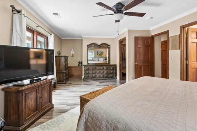 a bathroom with a toilet sink a mirror and shower