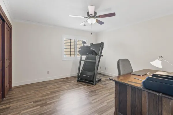 a bedroom with a bed a chandelier and a window