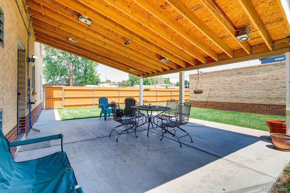 2050 Perry Street Denver, CO 80212 - Photo 8 of 15 a patio with glass top table and chairs