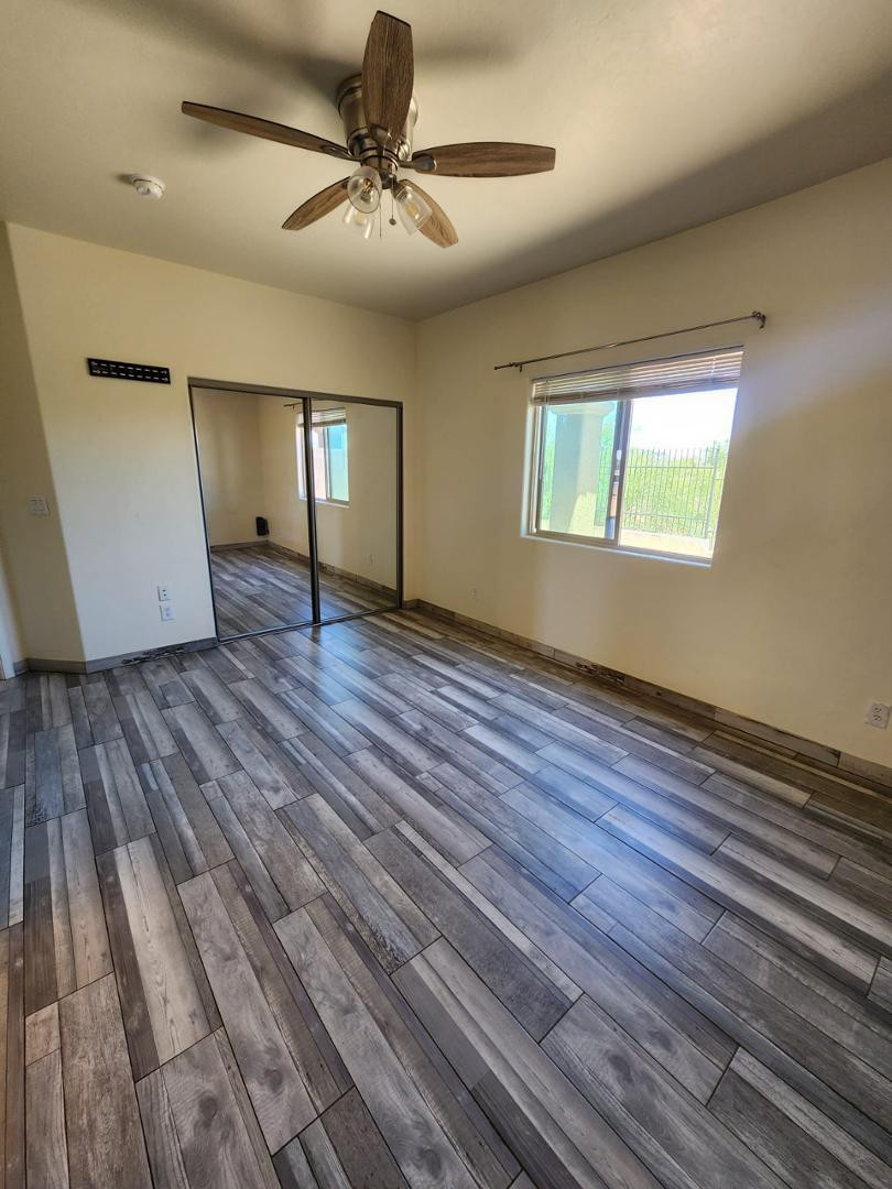 3641 Camino Del Rancho Douglas, AZ 85607 - Photo 9 of 20 wooden floor in an empty room with a window