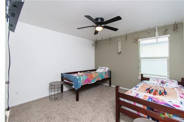 a bedroom with a bed a desk and chair