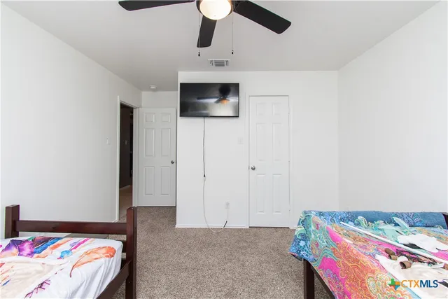 a bedroom with a bed and a tv