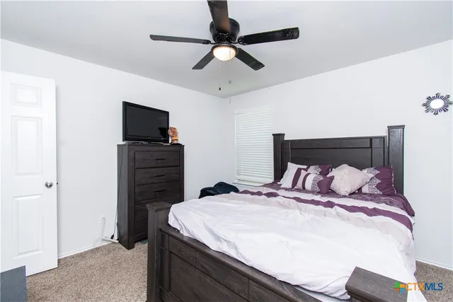 a bedroom with a bed and a television