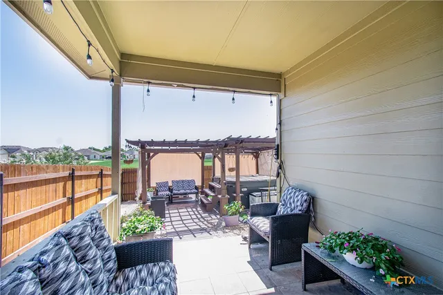 a balcony with furniture and a potted plant
