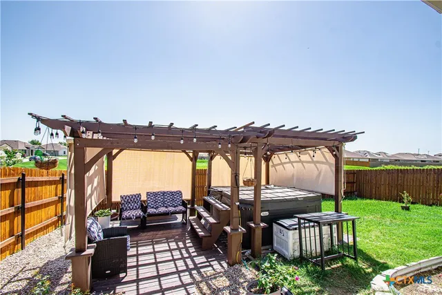a view of a patio with a table chairs and a backyard