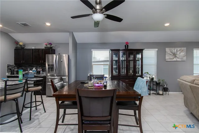 a dining room with furniture and window