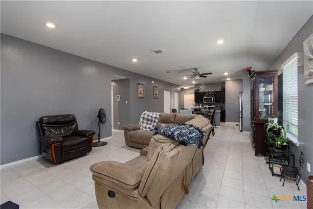 a living room with furniture gym equipment and a large window