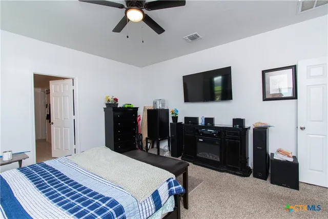 a bedroom with a bed and a flat tv screen