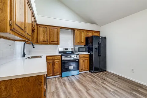 a kitchen with a refrigerator sink and stove