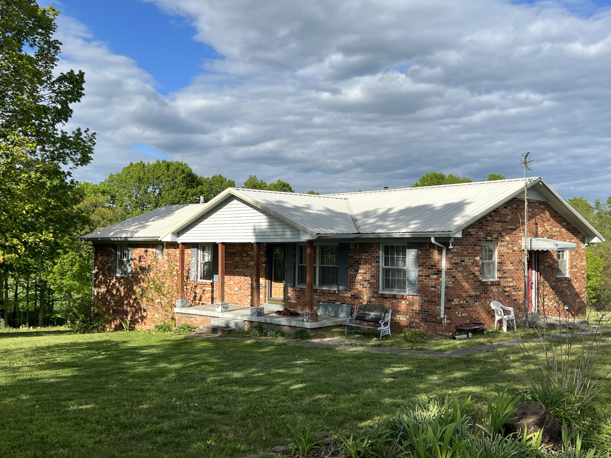 a front view of a house with a garden
