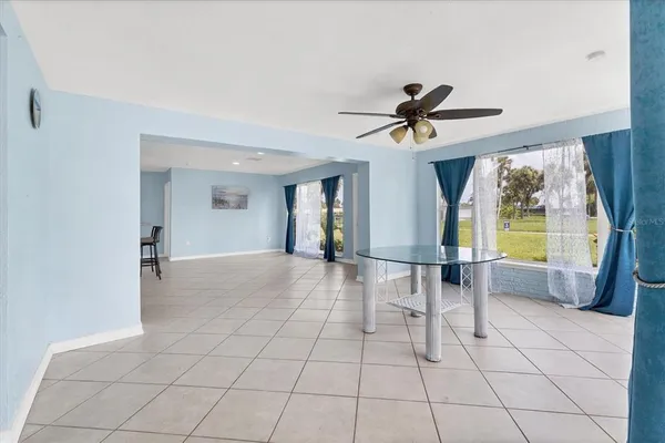 a view of a livingroom with furniture and a ceiling fan