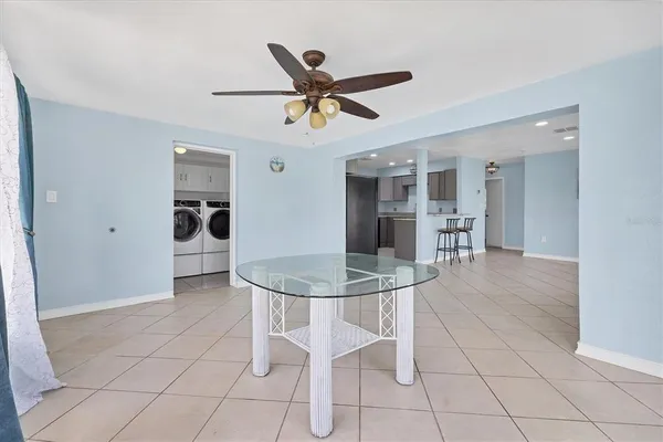a view of a dining room with furniture and a ceiling fan