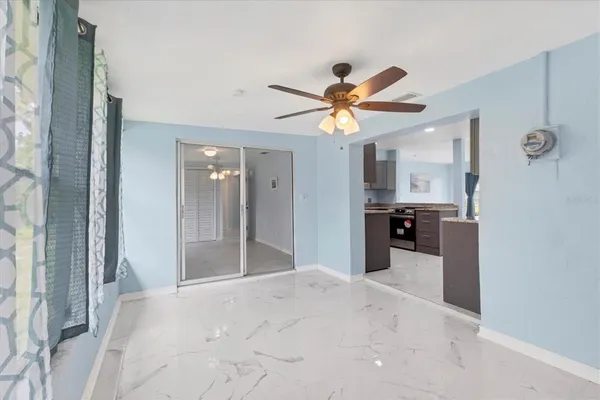 a view of a kitchen with a sink and a chandelier fan