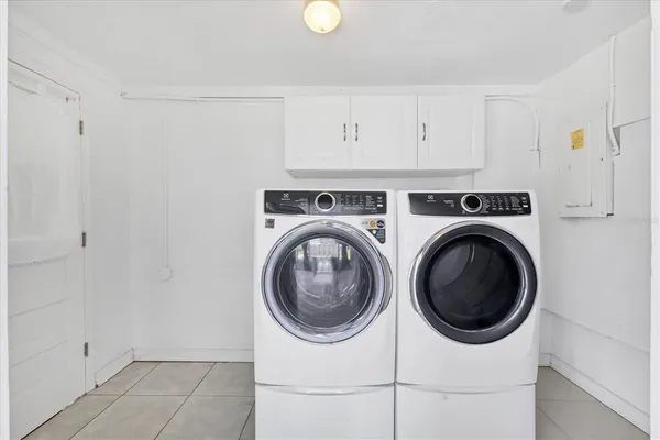 a utility room with sink dryer and washer