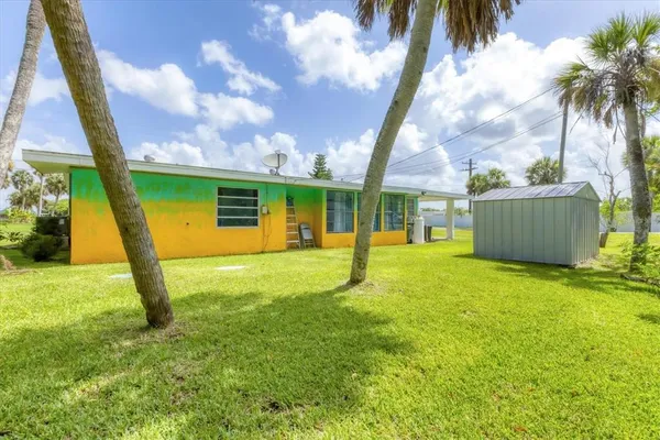 a view of a backyard with a garden and entertaining space