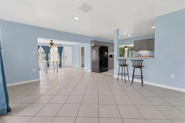 a view of kitchen with furniture and refrigerator