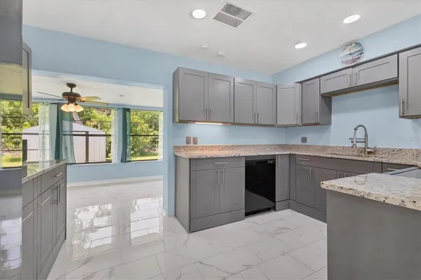 a kitchen with a sink window and cabinets